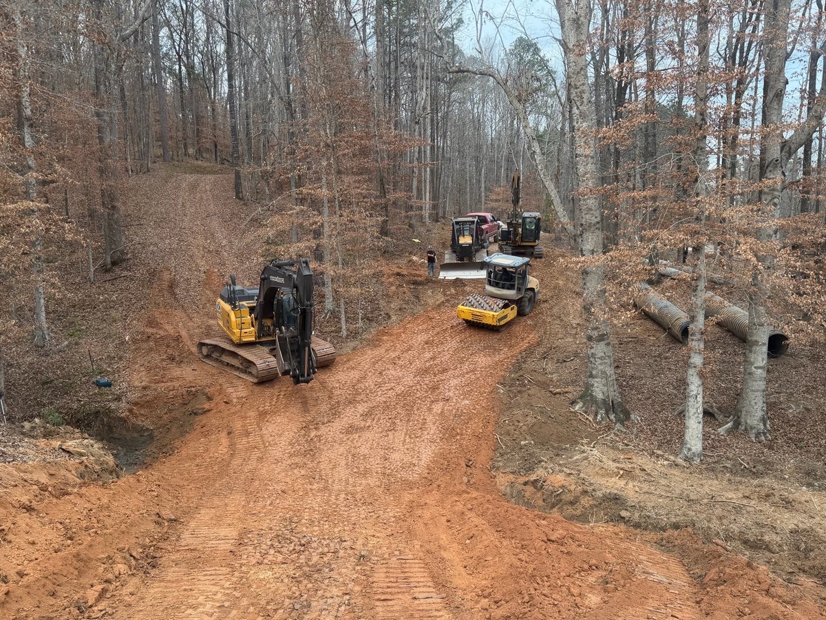 CAT articulated dump truck hauling red clay on site